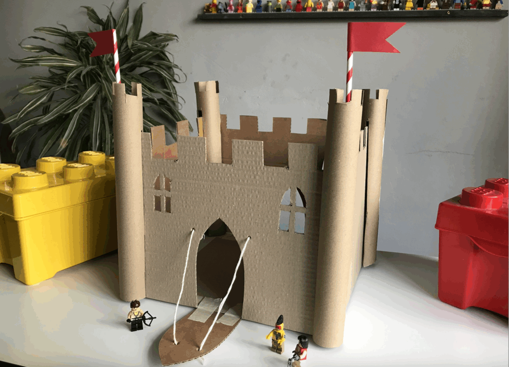 DIY castle made from cardboard boxes and painted by kids